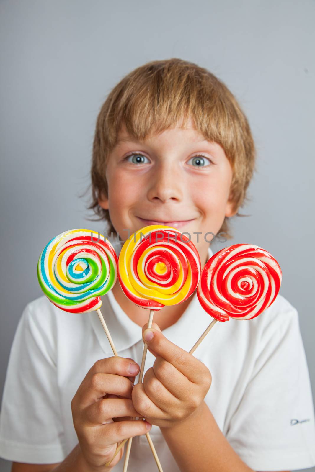 child boy eating lollipop by anelina