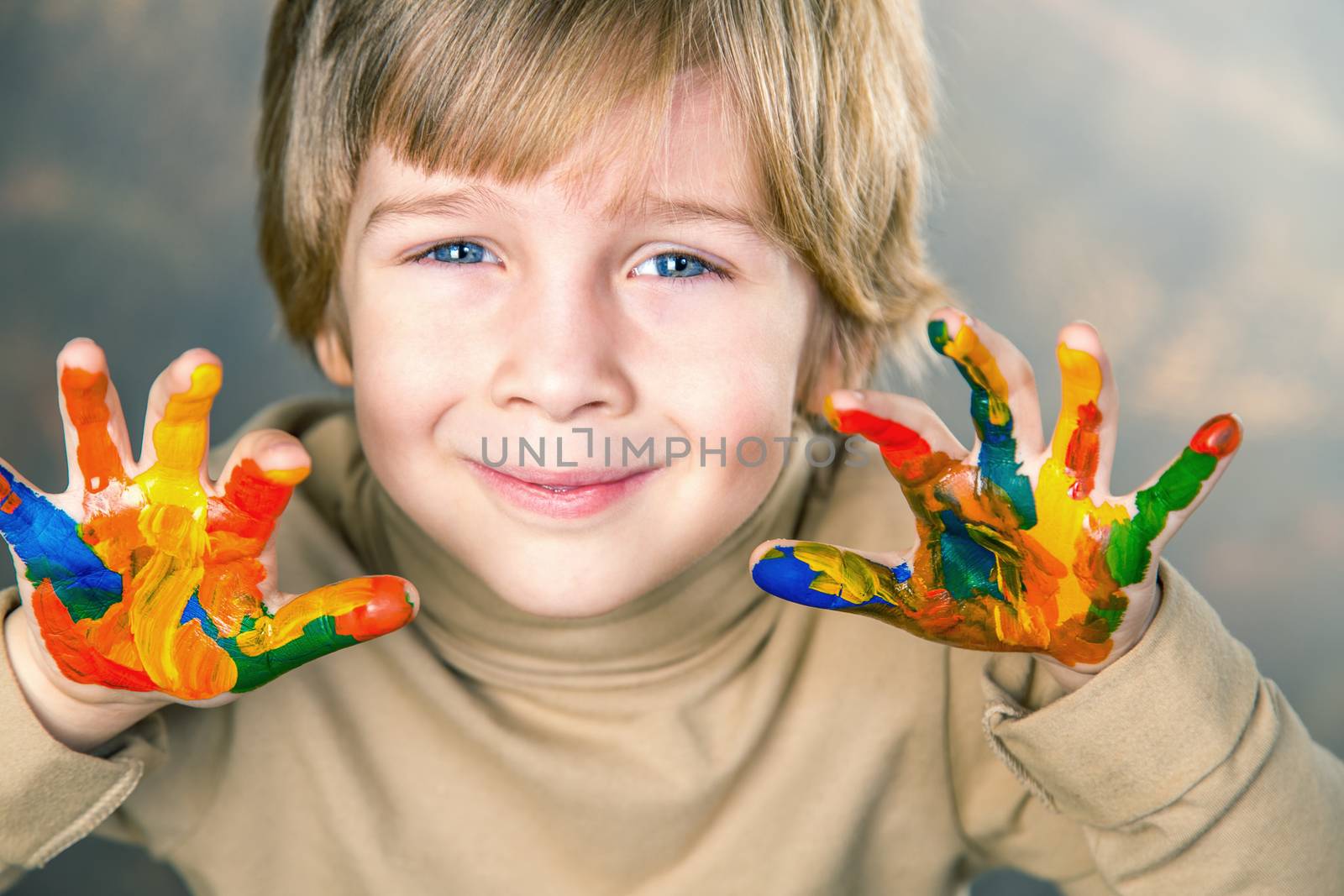 little boy hands painted  in colorful paints