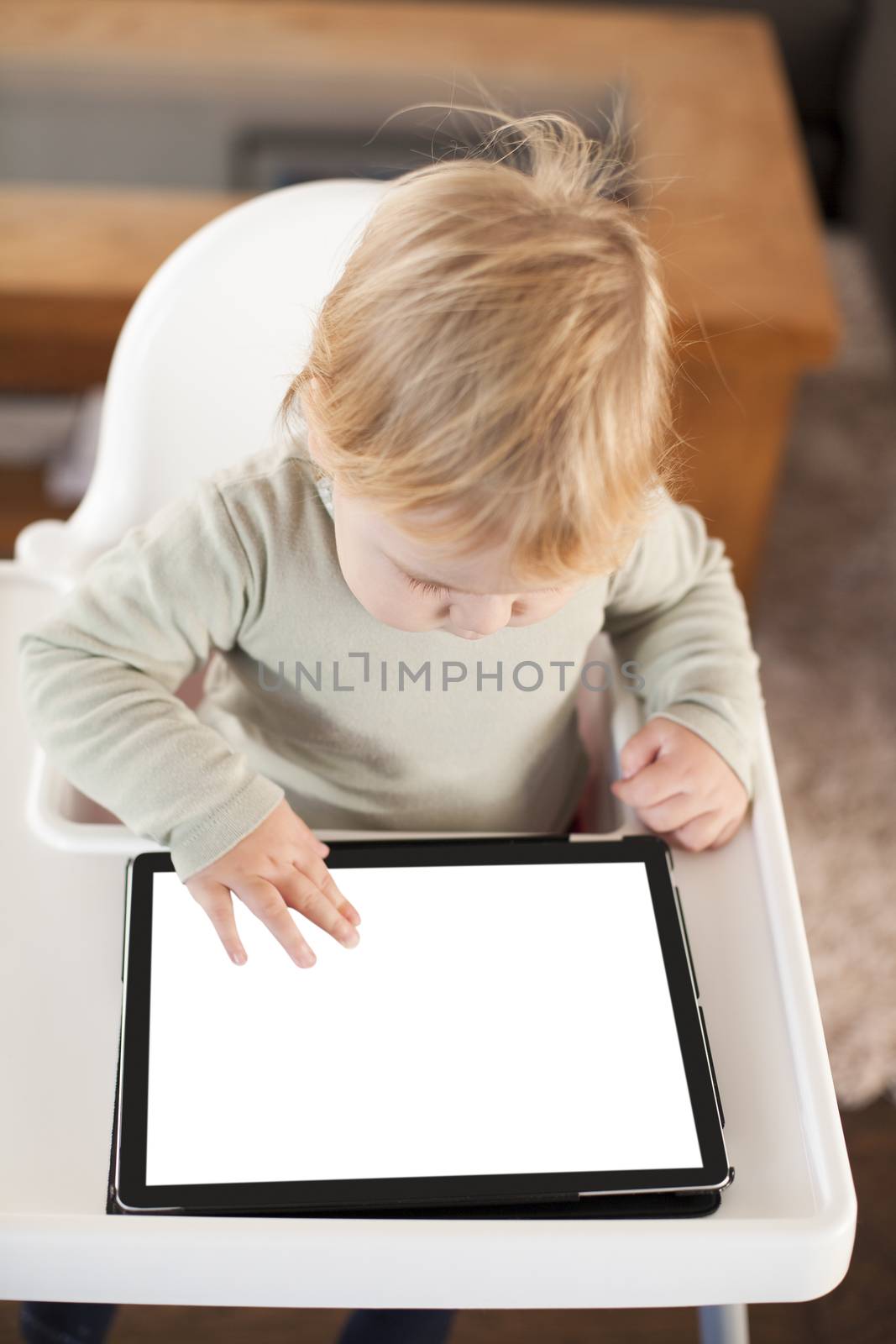 baby touching screen tablet by quintanilla