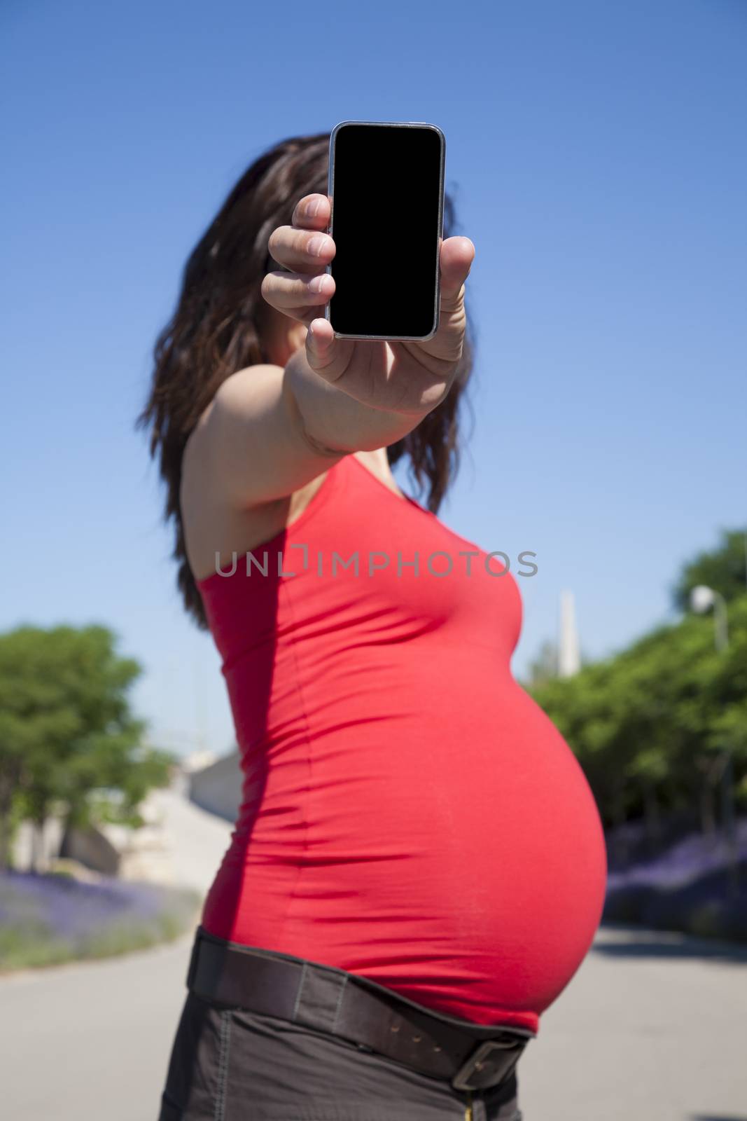 pregnant woman showing blank smartphone screen