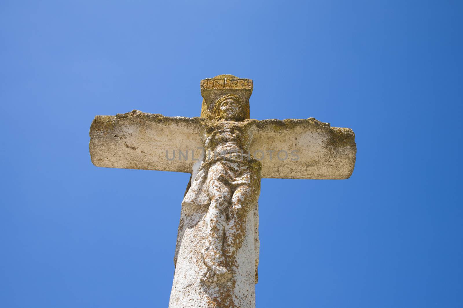 ancient stone crucifix by quintanilla