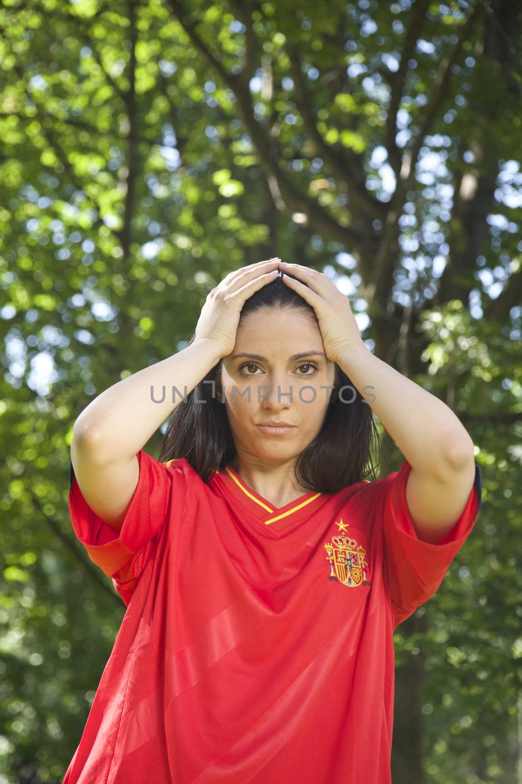 young woman with red spanish football team shirt unhappy
