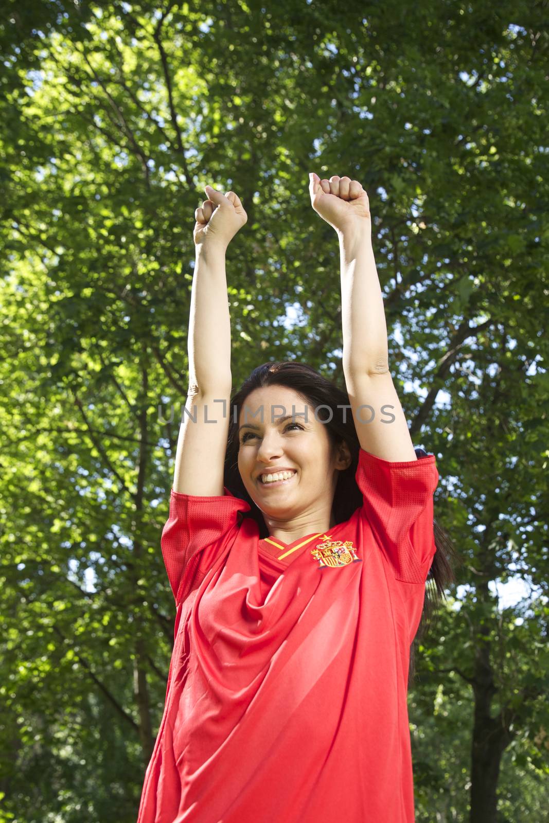 woman with spanish football team shirt cheering happy
