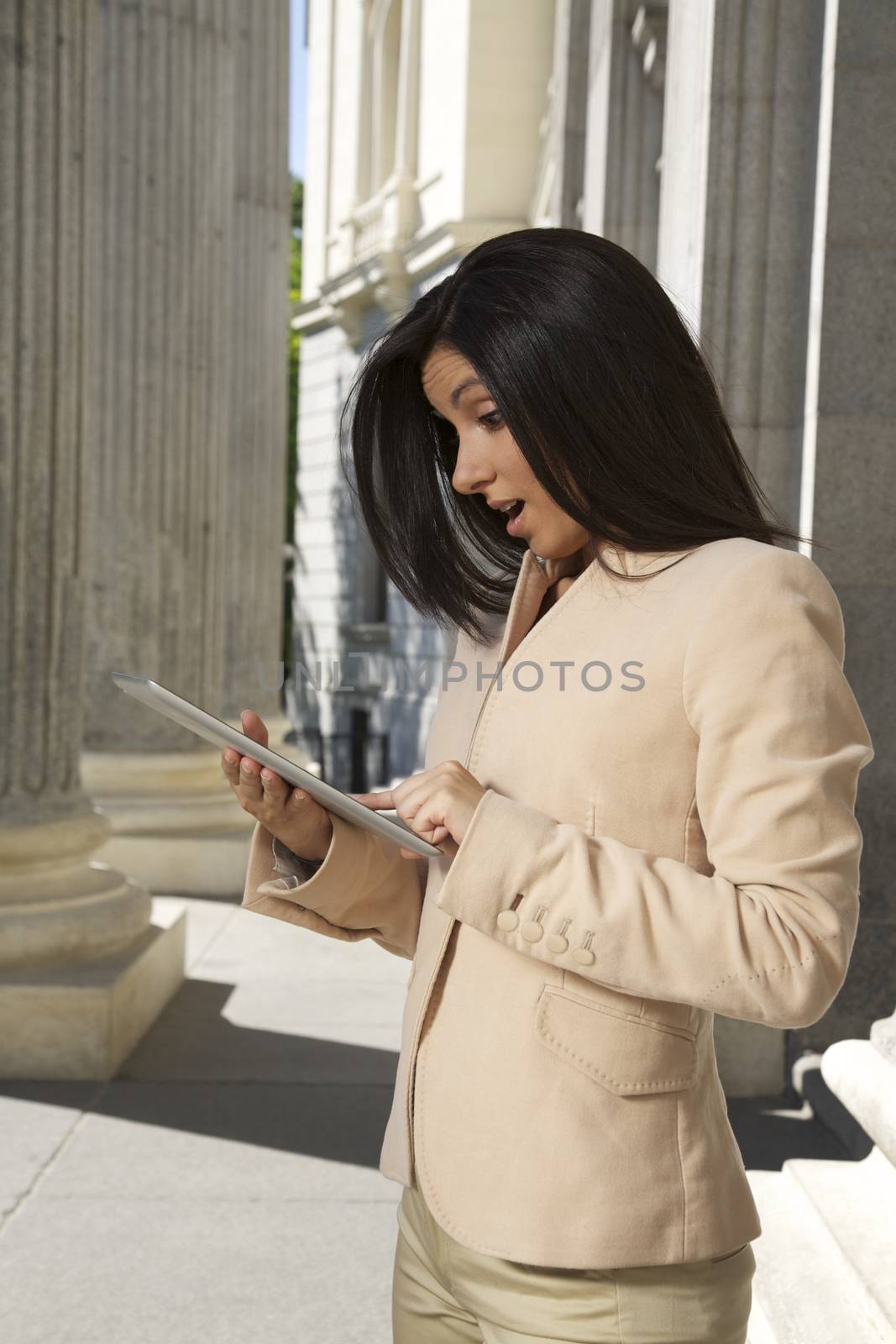 surprising businesswoman with tablet by quintanilla