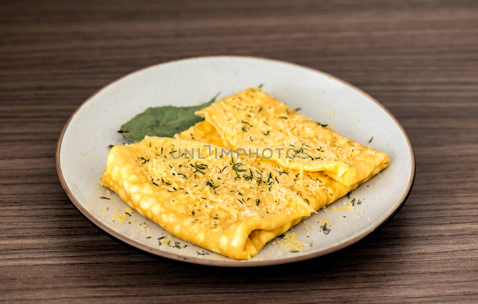 Delicious breakfast dish of omelette with parmesan cheese and thyme