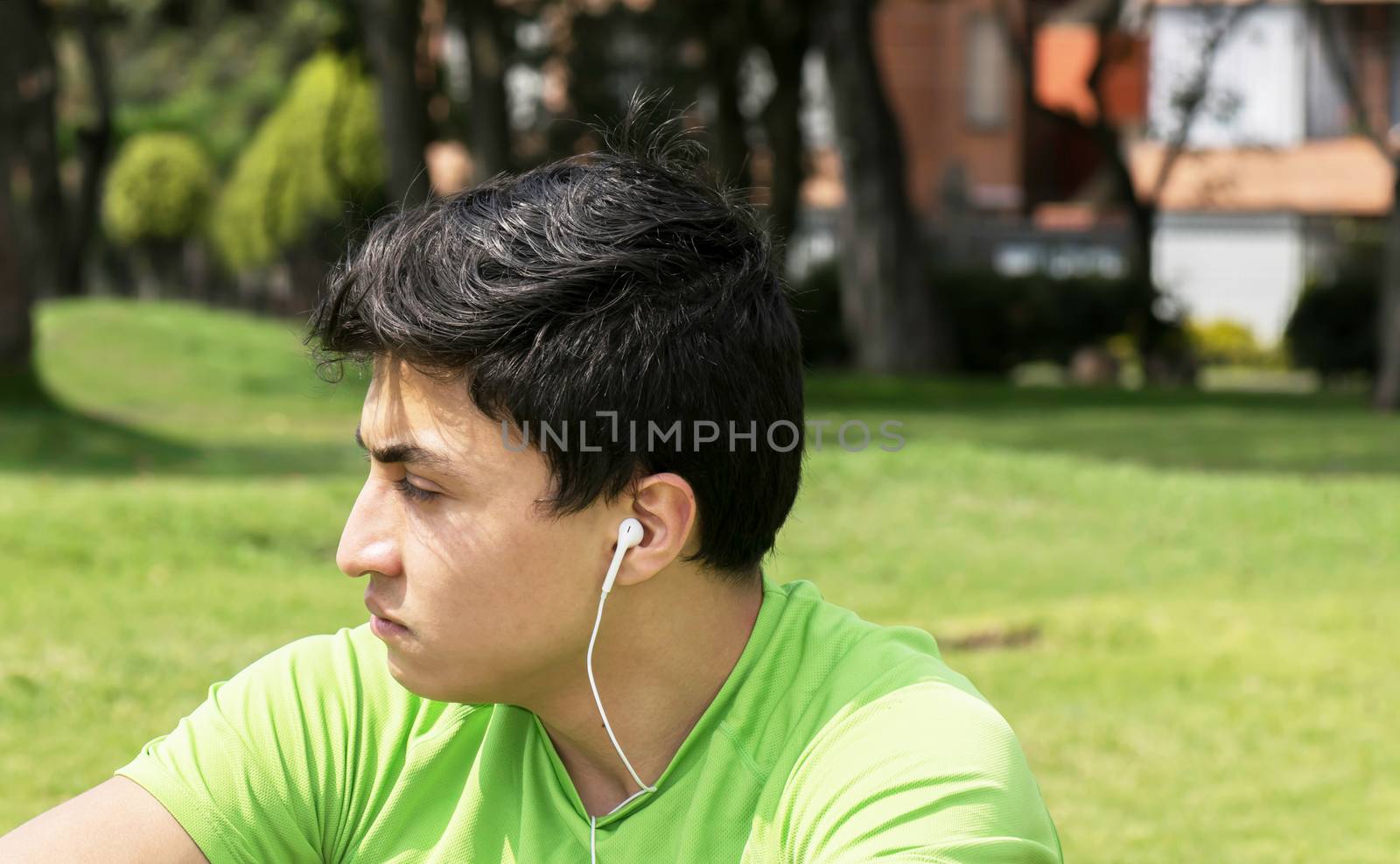 Young man at a local park taking a break and thinking about workout