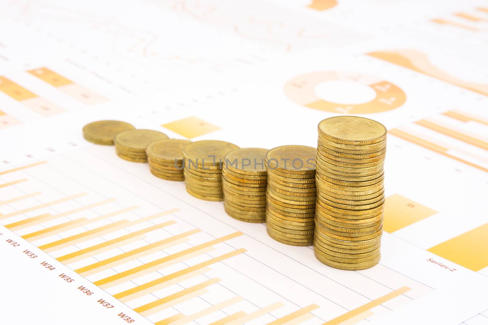 raising stacks of golden coins on yellow business graph, data and report background, concepts of inflation, investment, saving, trading and banking