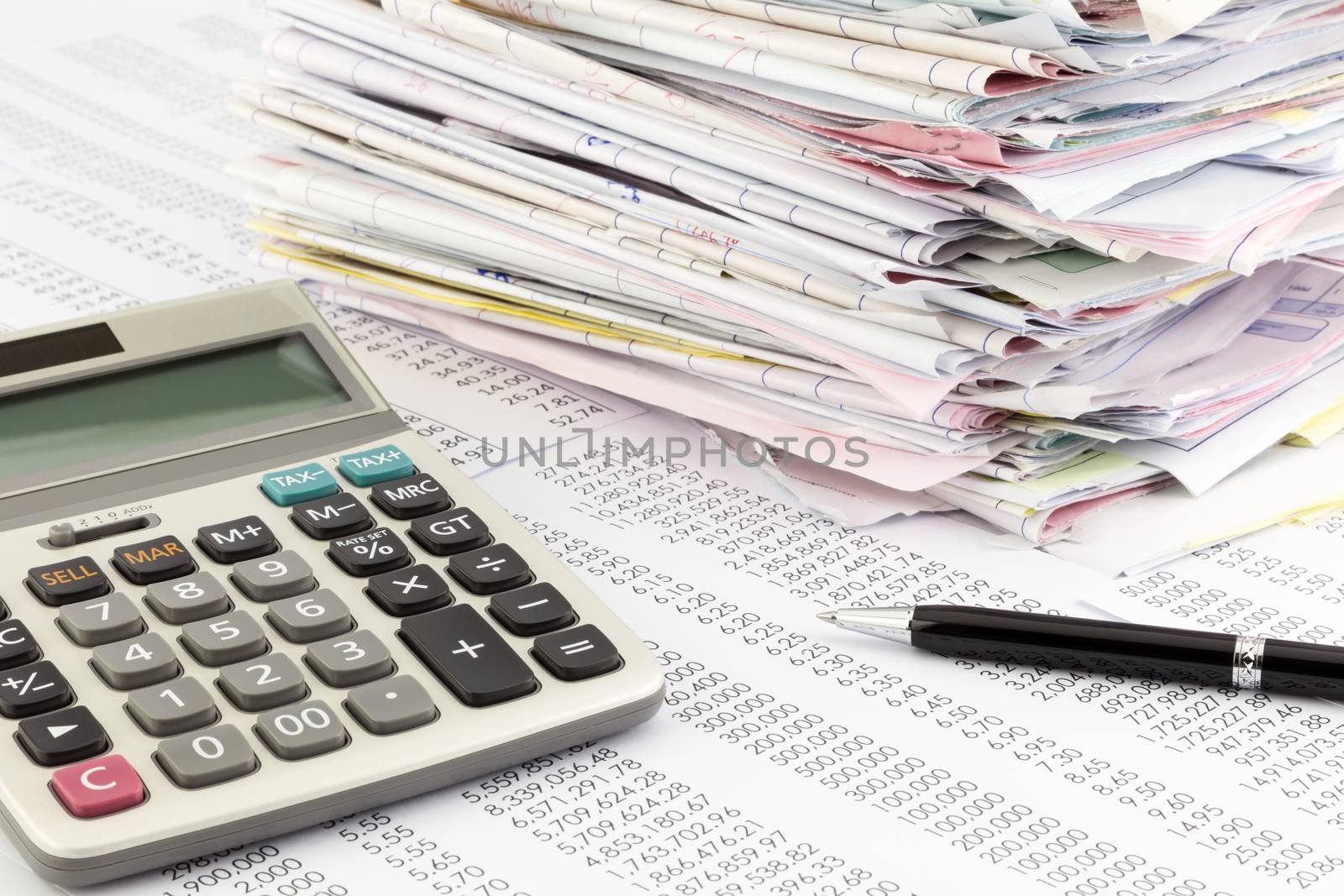 calculator and invoices on financial summary report