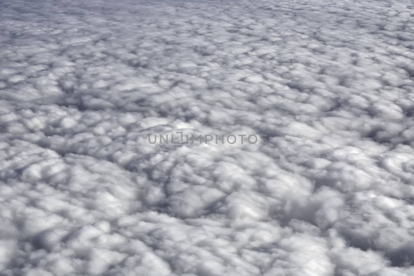 Fluffy rain clouds shot from an airplane