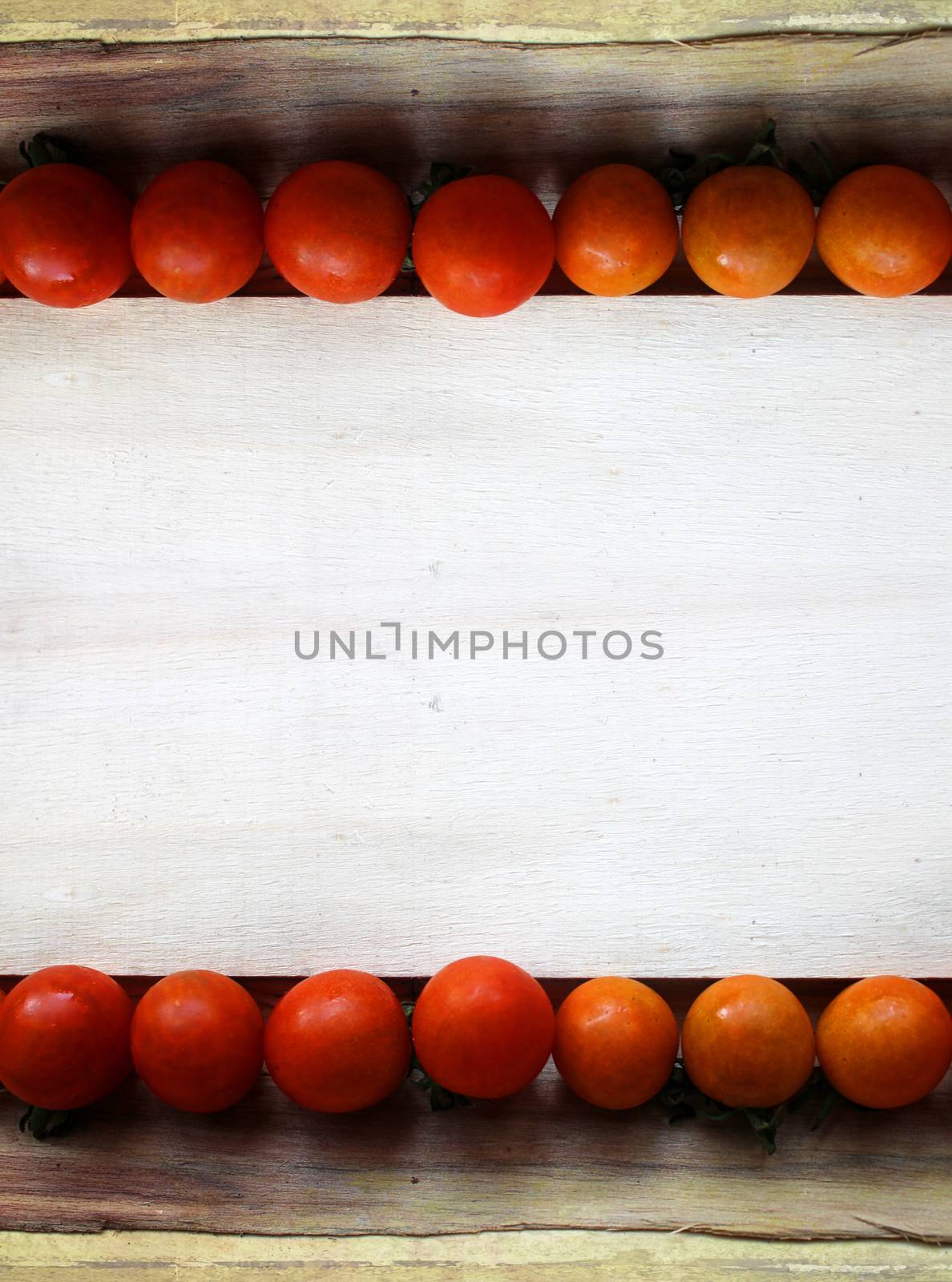 cherry tomatoes on wood - grunge frame