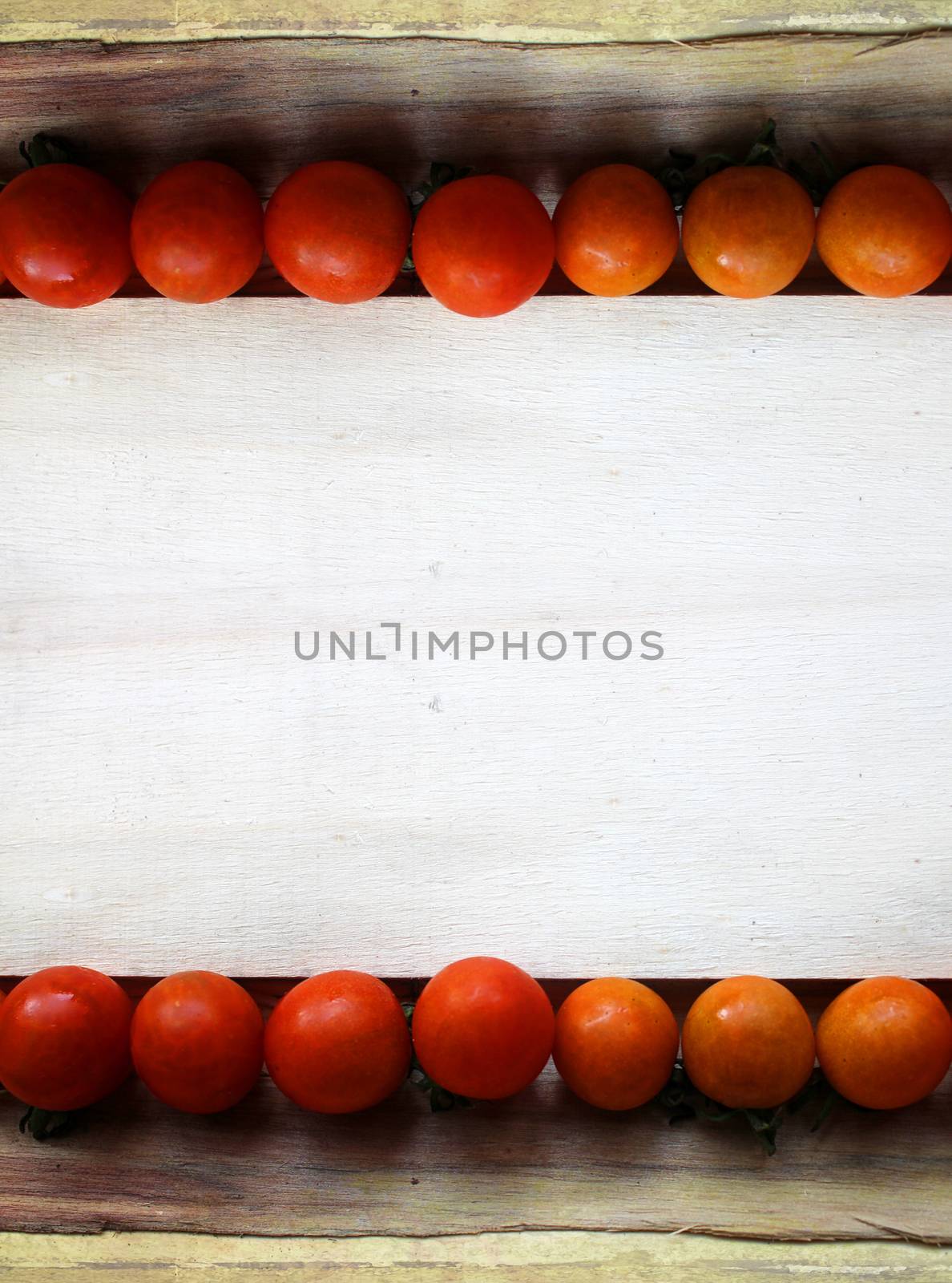 cherry tomatoes on wood - grunge frame