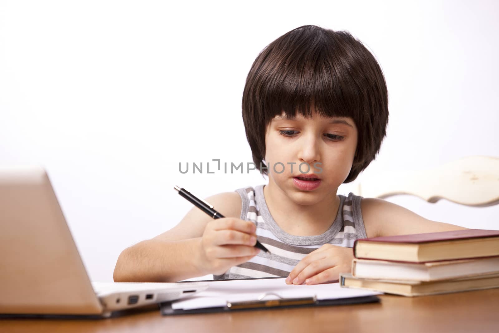 young schoolboy does his homework