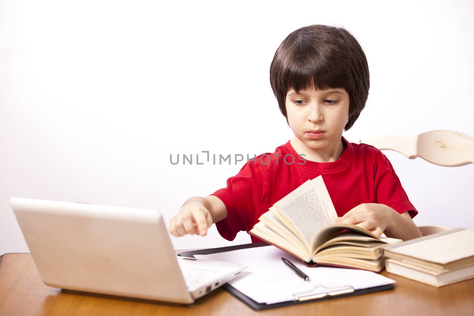 serious boy with a book and a netbook