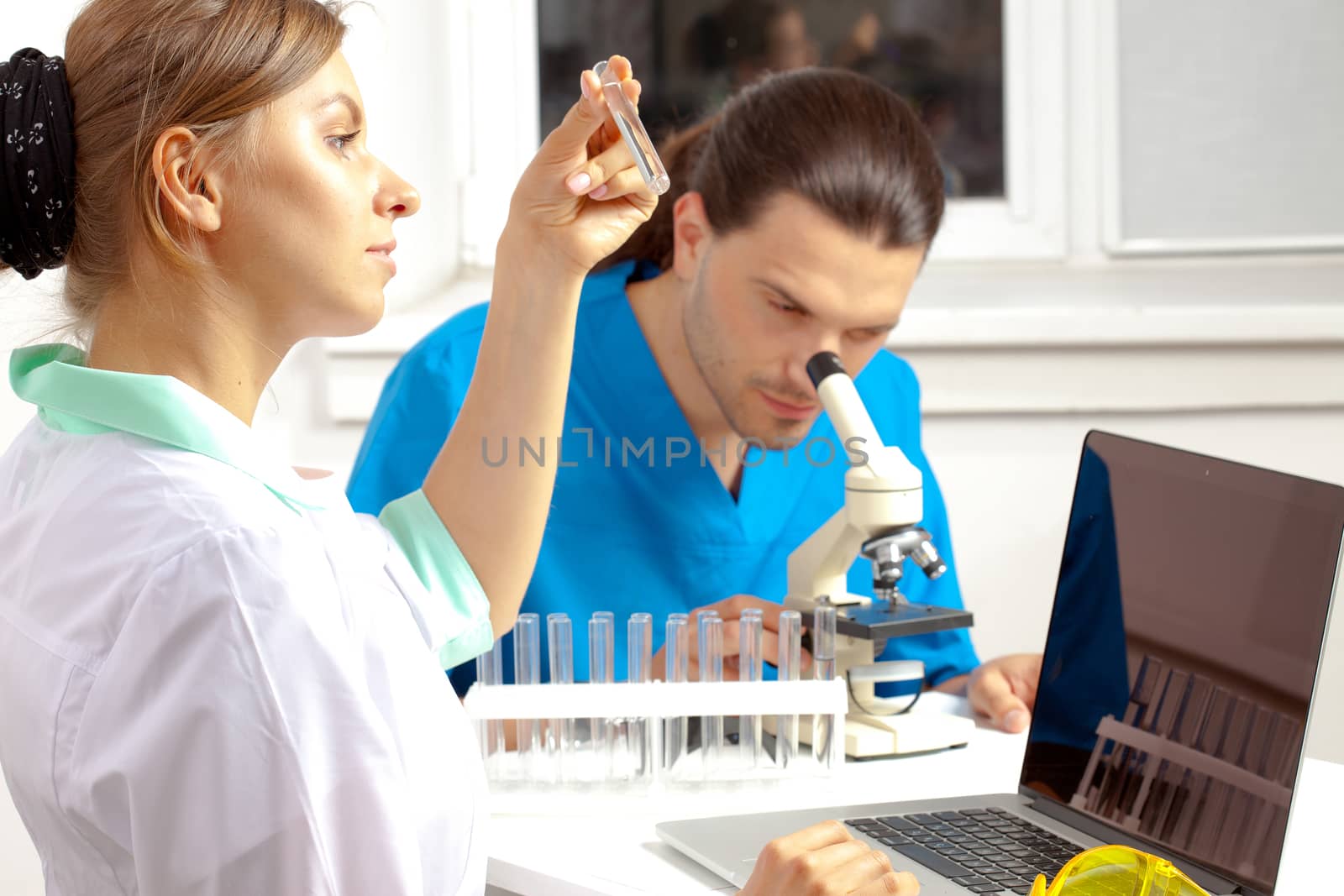 Doctor examines a test tube by Astroid