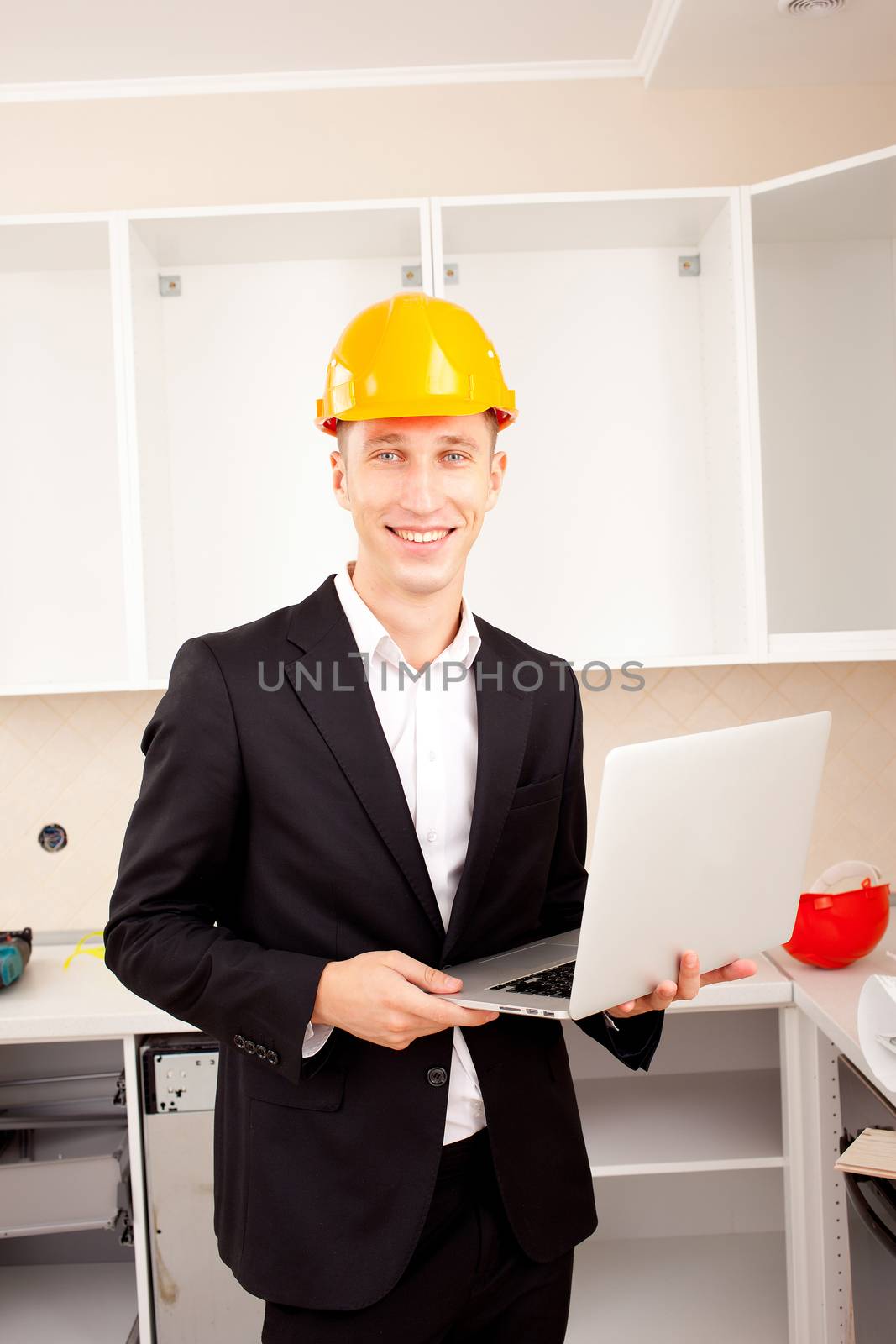 architect with laptop in the new apartment interior