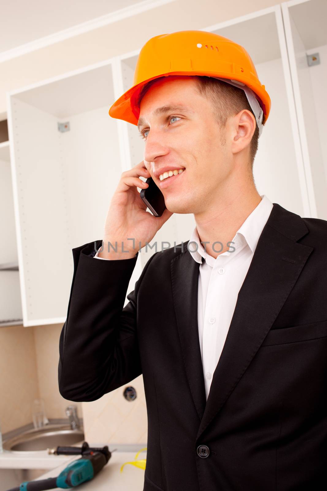 engineer talking on the phone in the interior of a new apartment