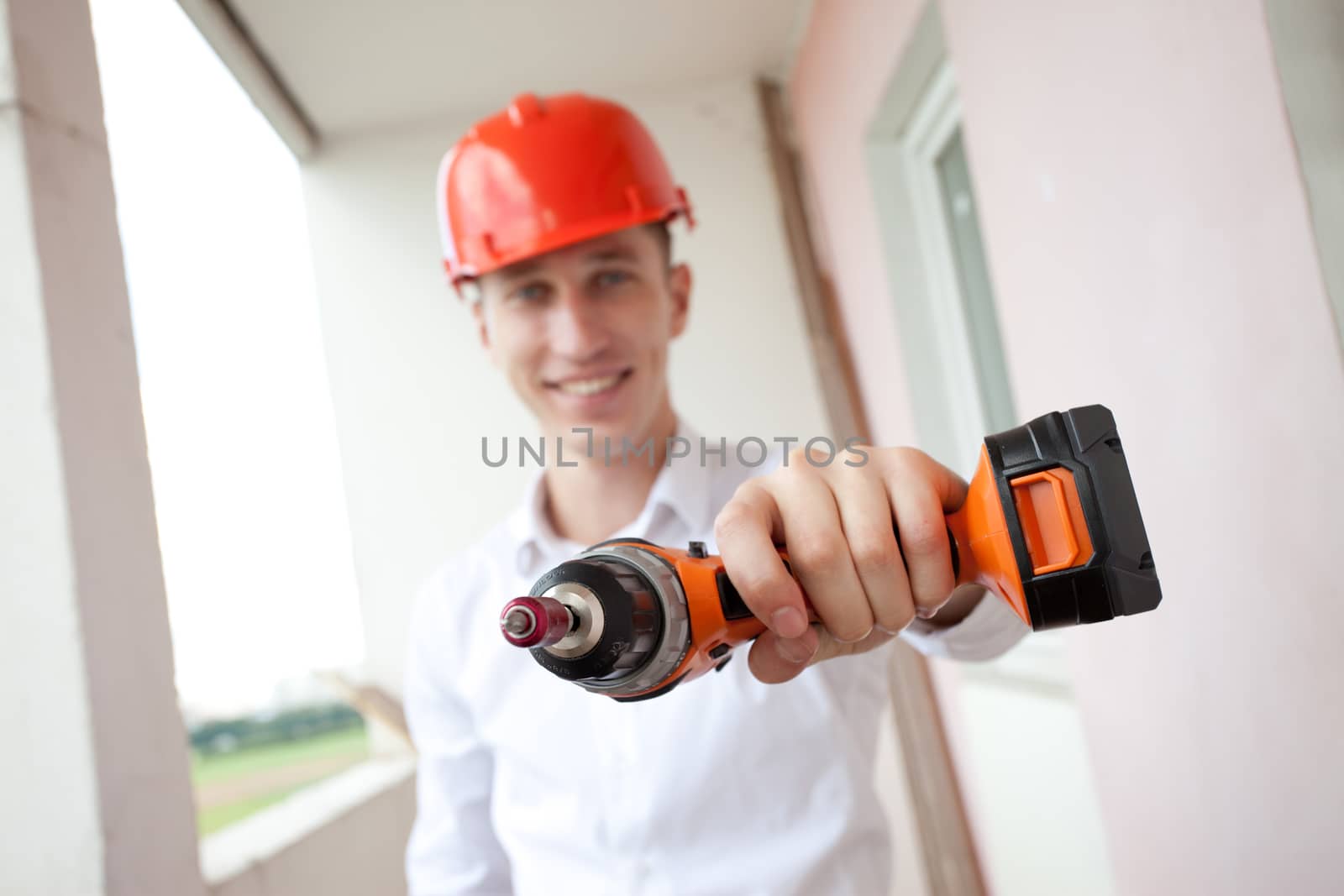 smiling worker with drill by Astroid