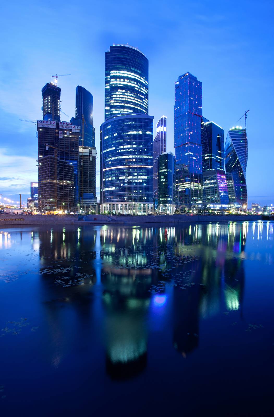 Russia - 30.06.2014, Moscow City skyscrapers at night reflected in the river. Editorial use only