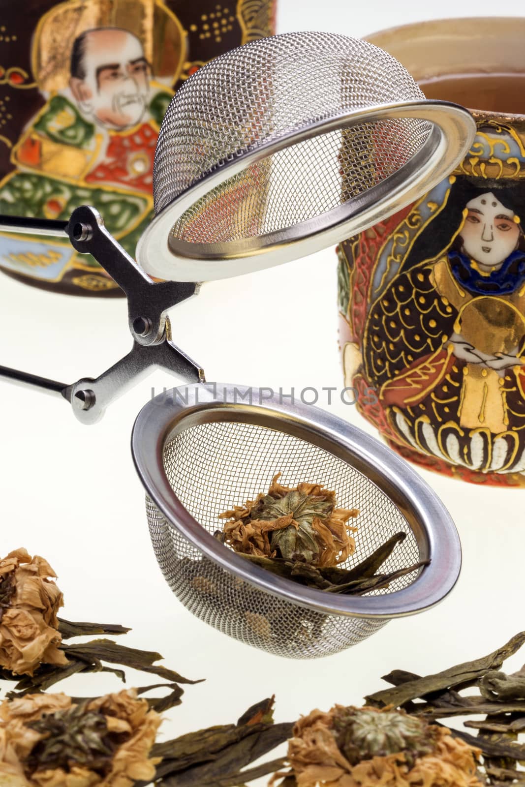 A Tea Infusing Basket or Brewing Basket and floral green tea. 