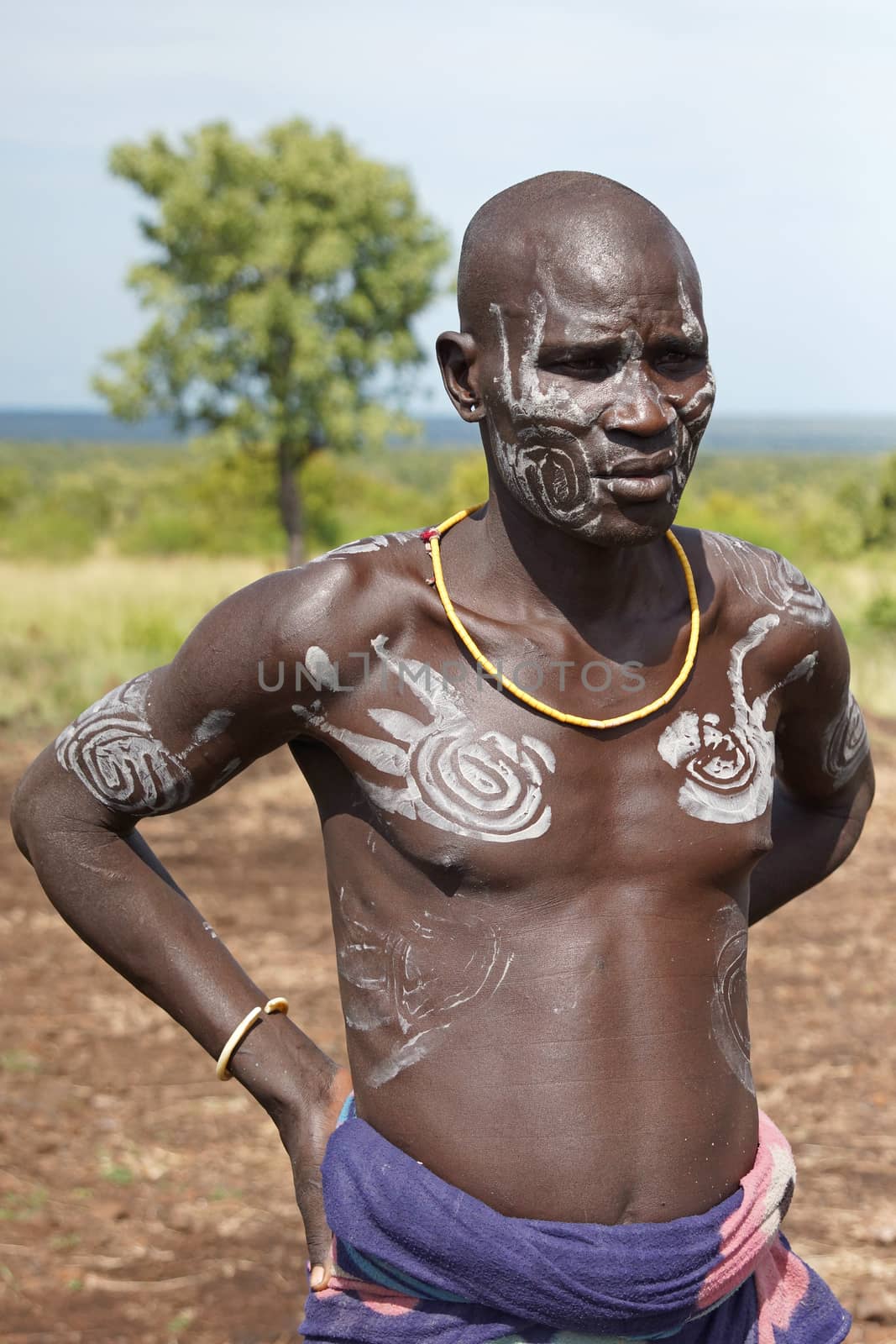 JINKA, ETHIOPIA - NOVEMBER 21, 2014: Portrait of a Mursi clan chief with traditional paintings on November 21, 2014 in Jinka, Ethiopia.