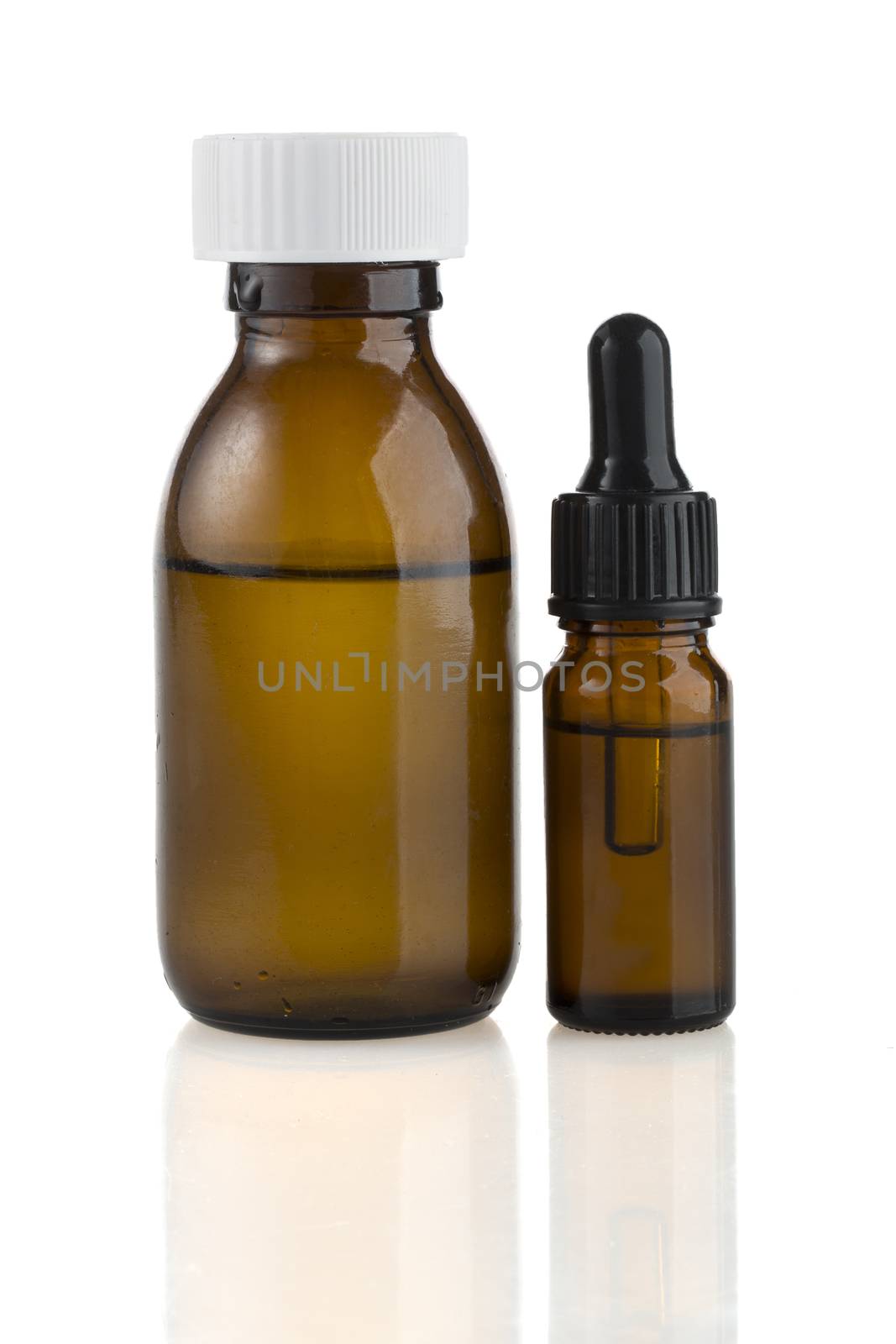 A medicine bottle and medicine dropper isolated on white.