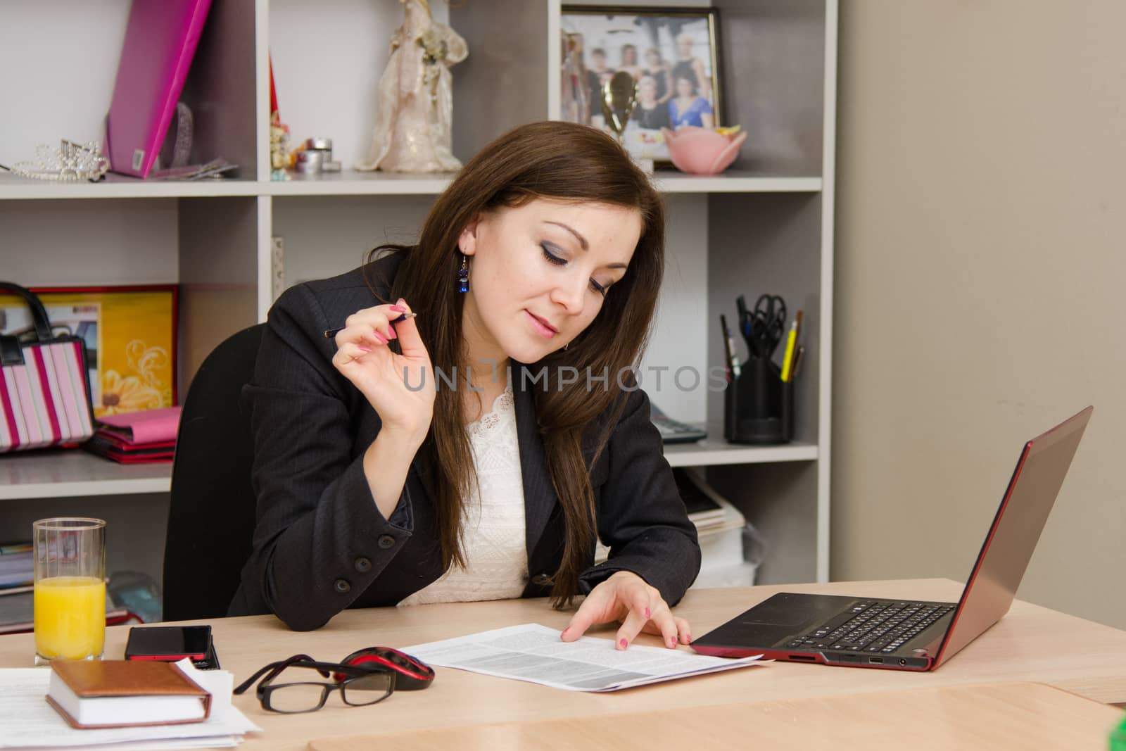 Cute business woman in the office at the computer