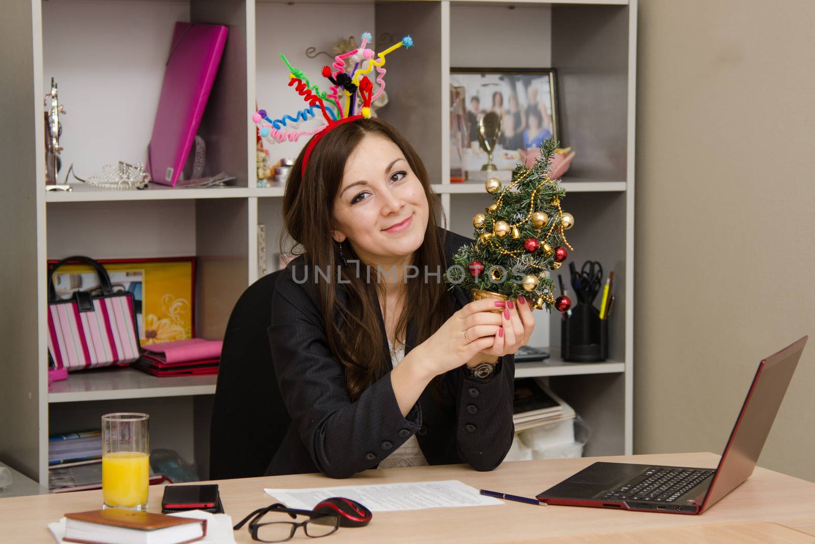 Cute business woman in the office at the computer