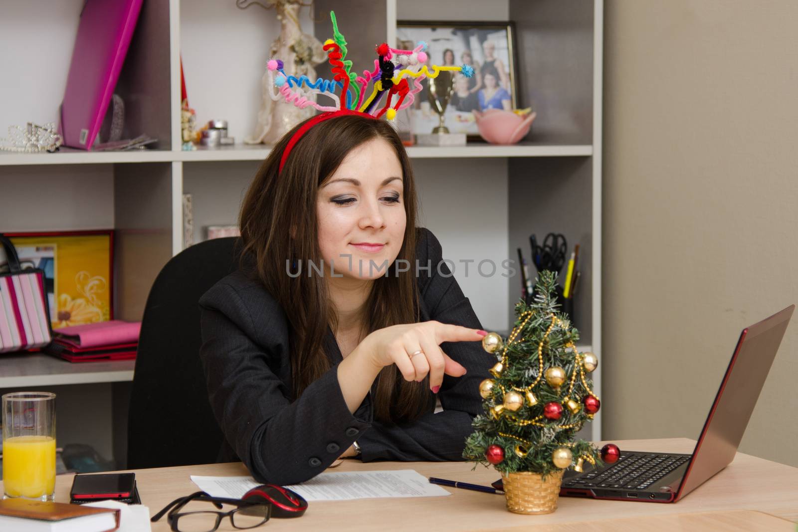 Cute business woman in the office at the computer