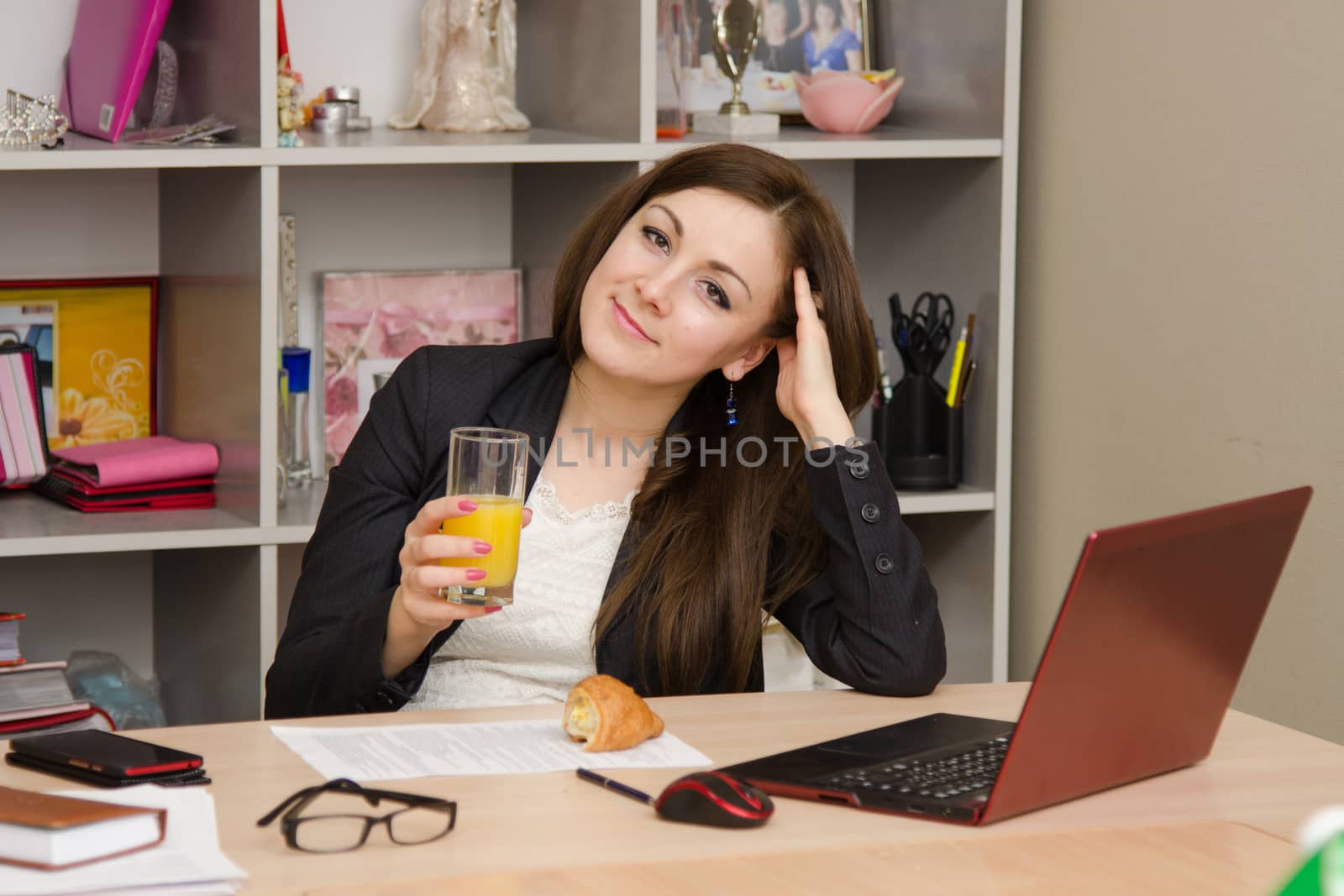 Cute business woman in the office at the computer