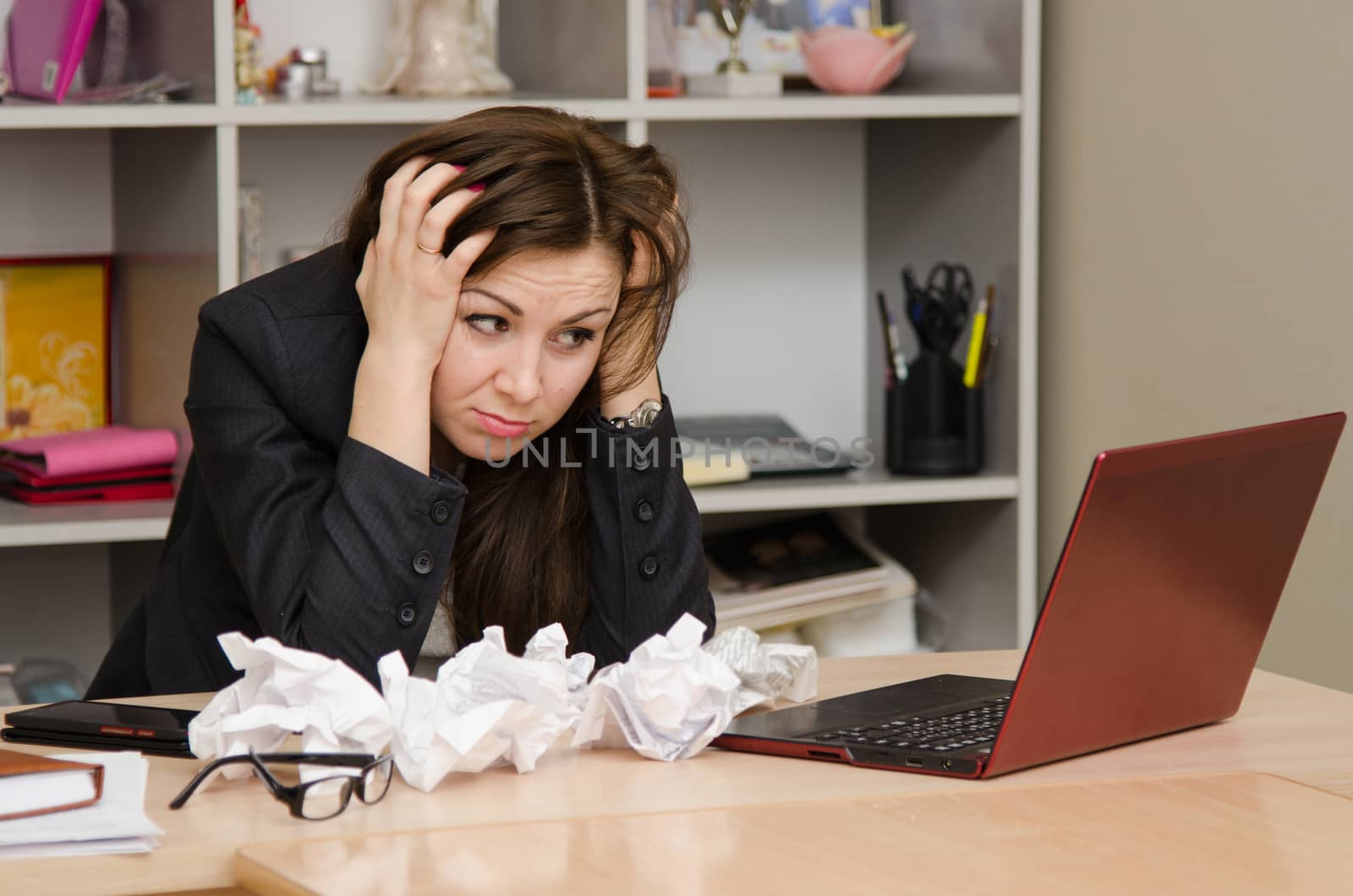 Cute business woman in the office at the computer