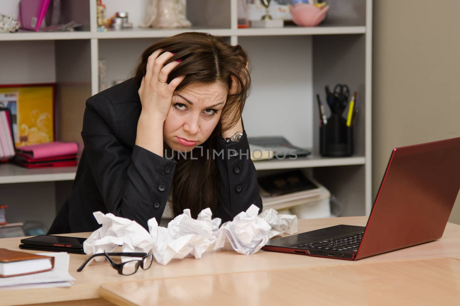 Cute business woman in the office at the computer