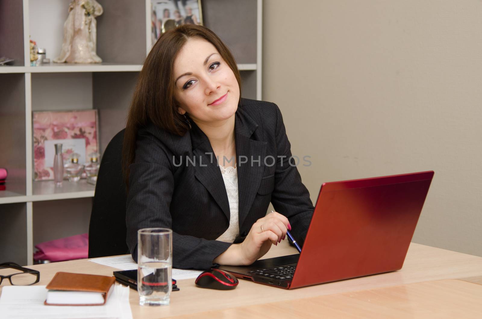 Cute business woman in the office at the computer