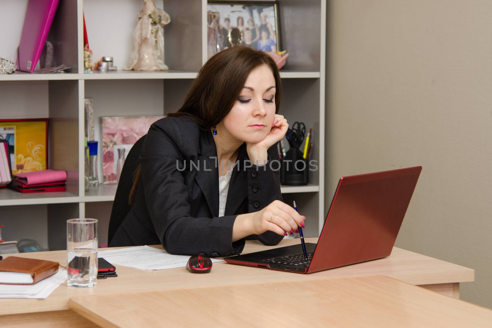 Cute business woman in the office at the computer