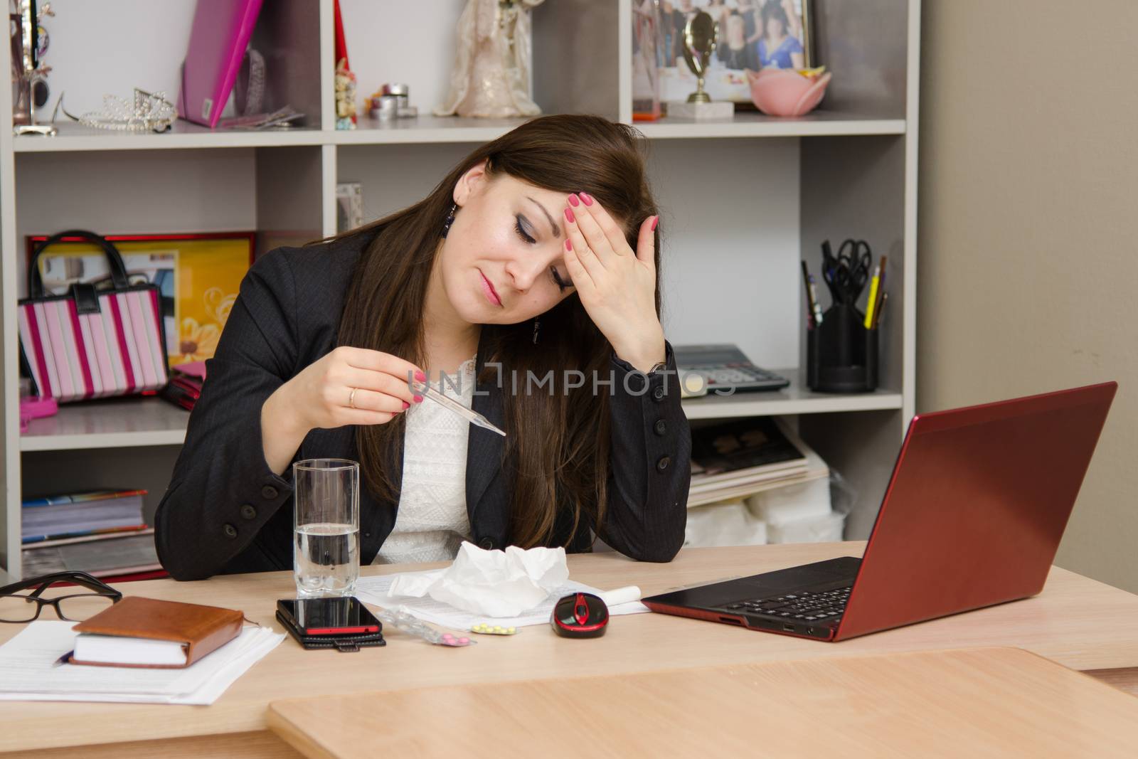 Cute business woman in the office at the computer