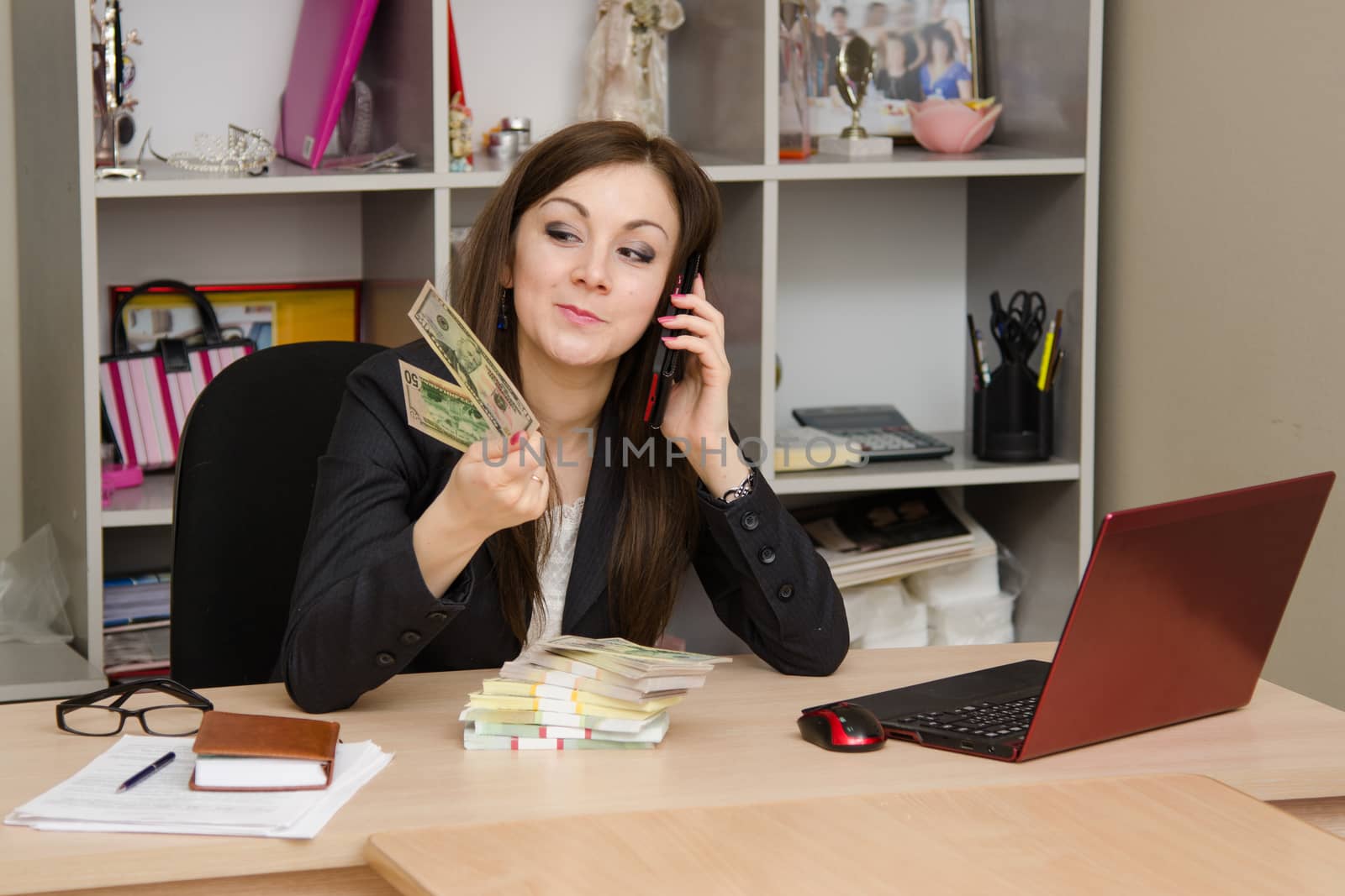 Cute business woman in the office at the computer