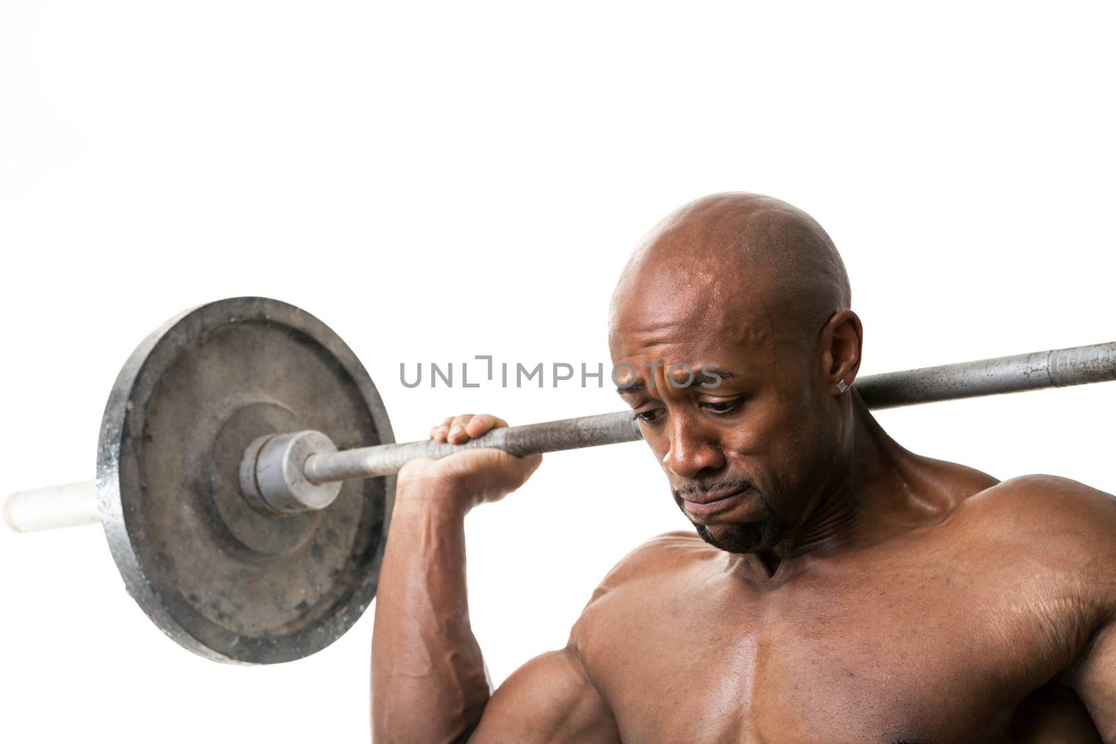 Toned and ripped lean muscle fitness man lifting weights isolated over a white background.