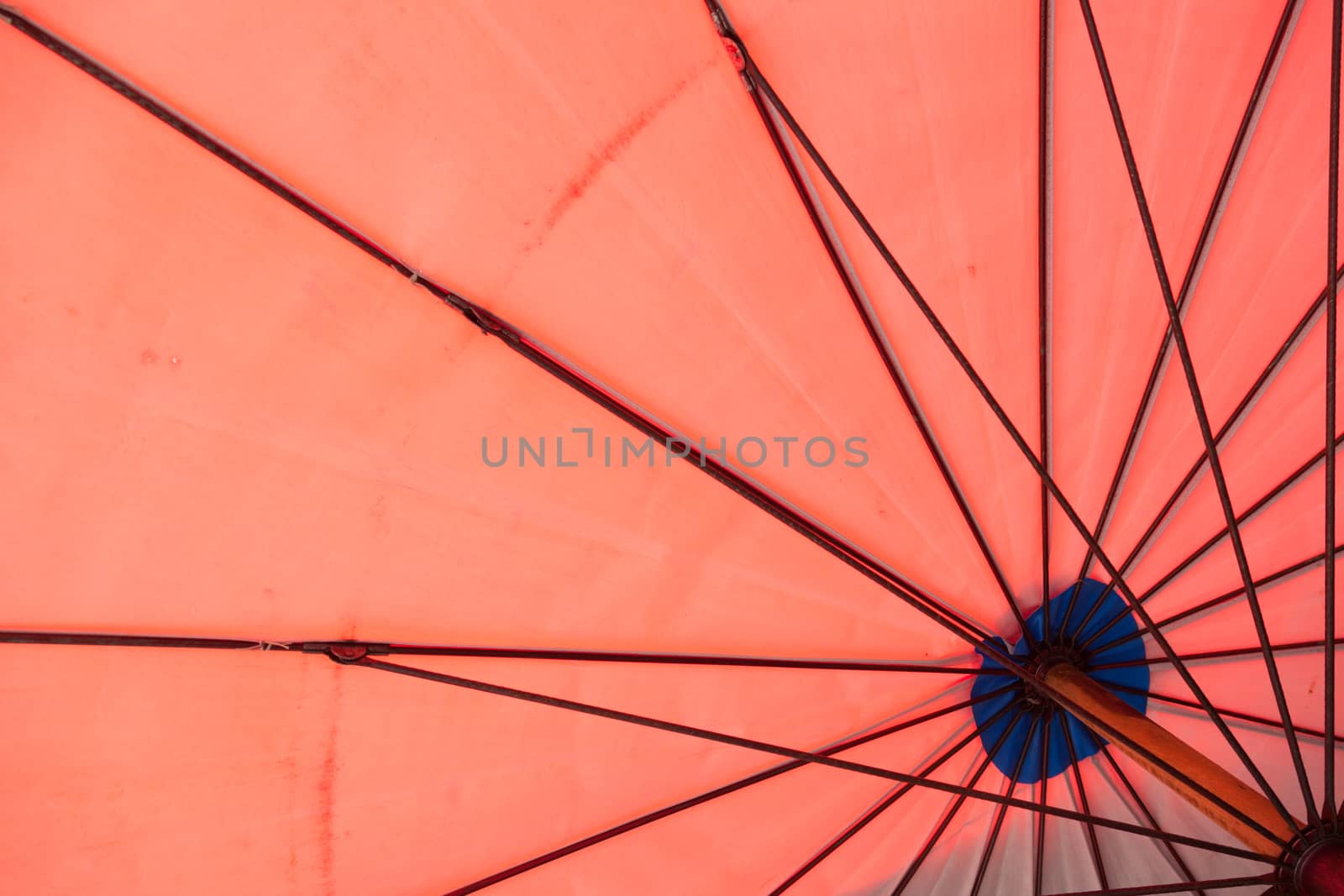 The shade of red. The components of a steel rod covered Dodge link structure of the umbrella.