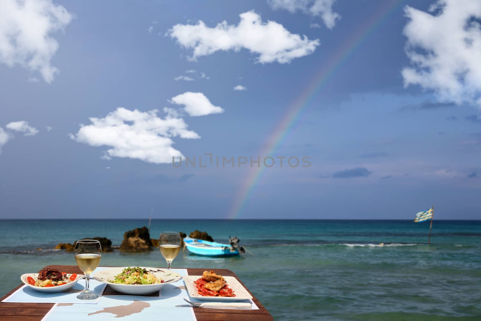 lunch table for two by the sea with nice rainbow