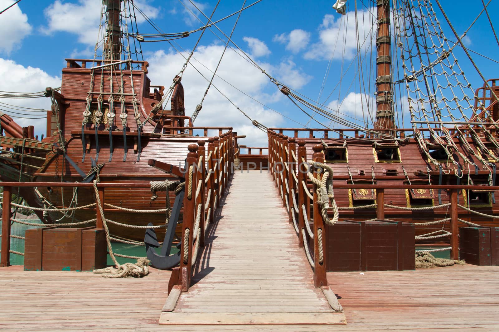 Entrance of pirate ship in park on cloudy background.