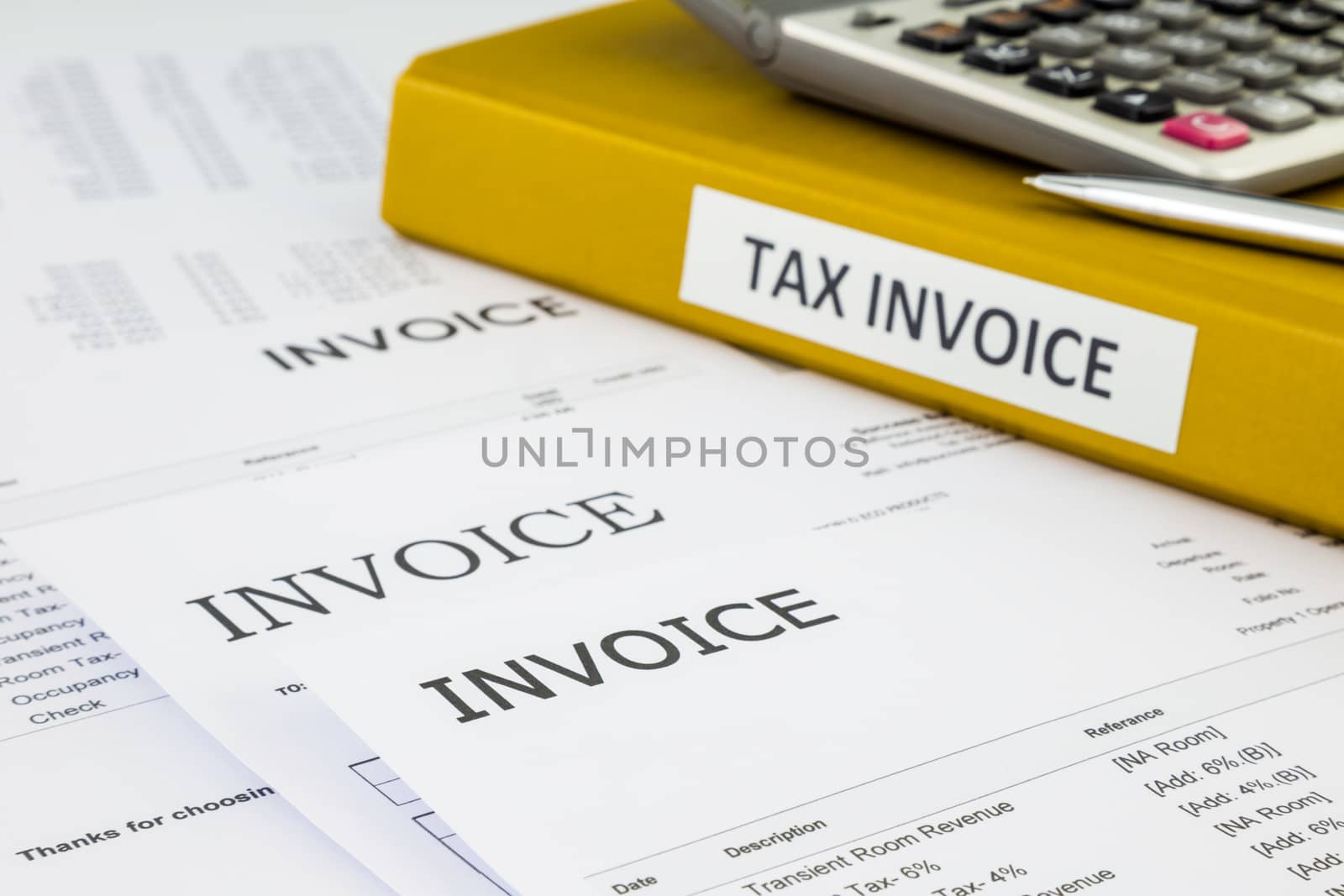 Binder of tax invoice documents with bills, purchase orders and business invoices on background