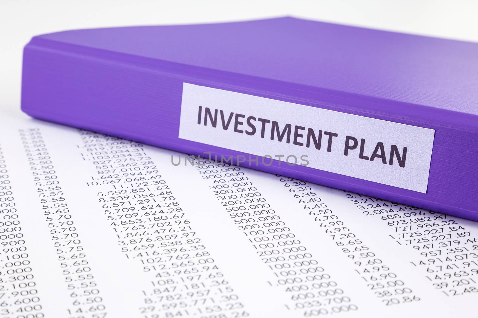 Financial report document with purple binder of investment plan, concept to financial accounting