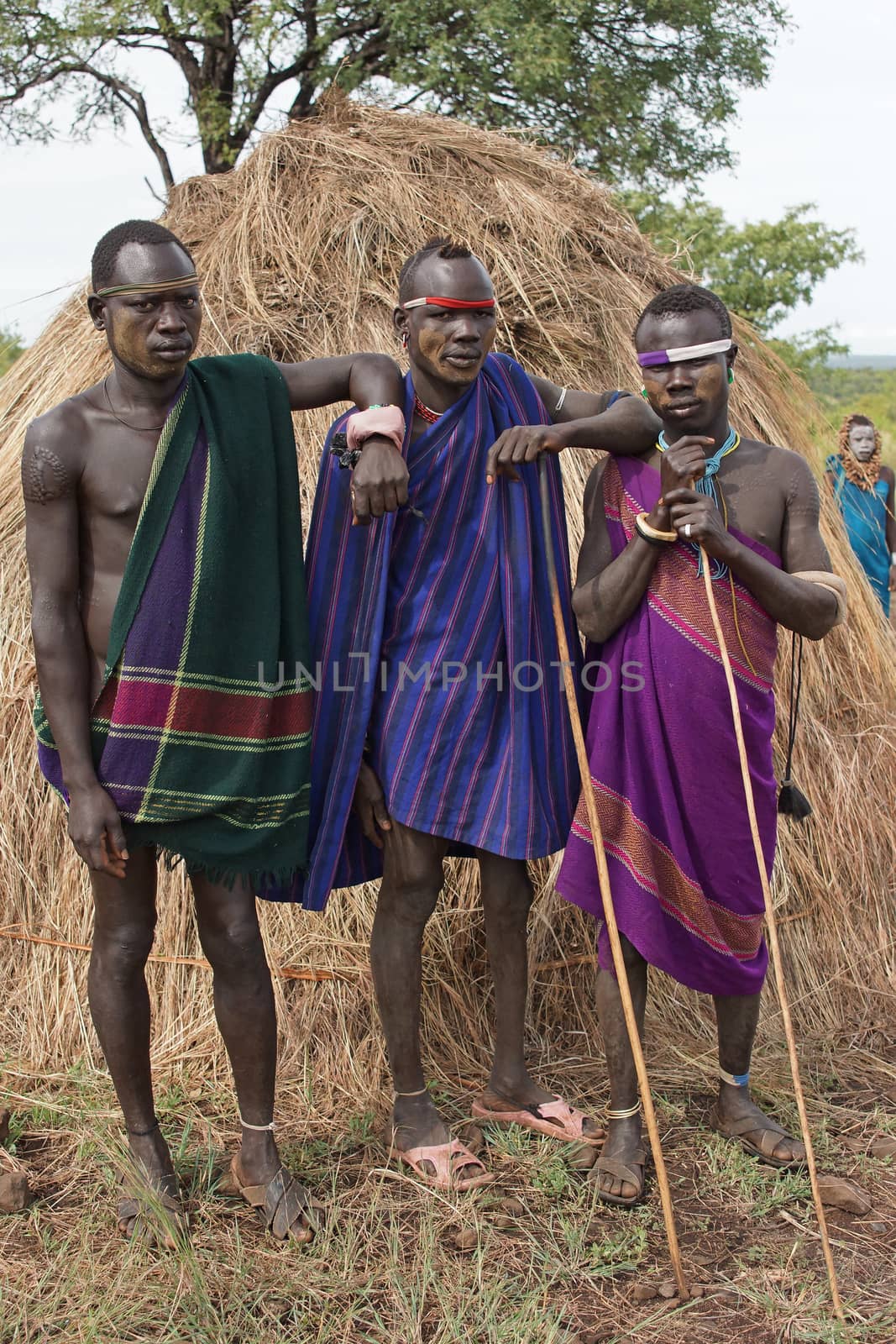 JINKA, ETHIOPIA - NOVEMBER 21, 2014: Mursi men with traditional clothings on November 21, 2014 in Jinka, Ethiopia.