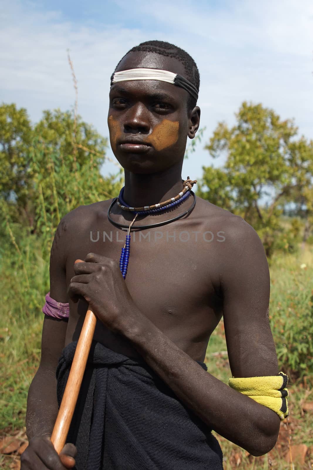 JINKA, ETHIOPIA - NOVEMBER 21, 2014: Portrait of a Mursi man with traditional paintings on November 21, 2014 in Jinka, Ethiopia.