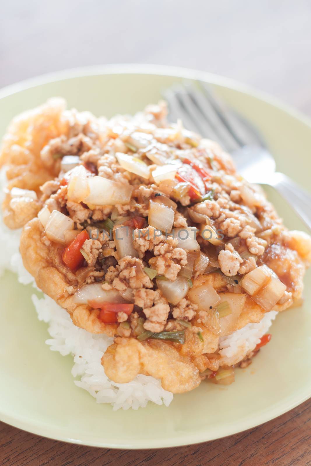 Fried pork with tomato sauce topping on fried egg by punsayaporn