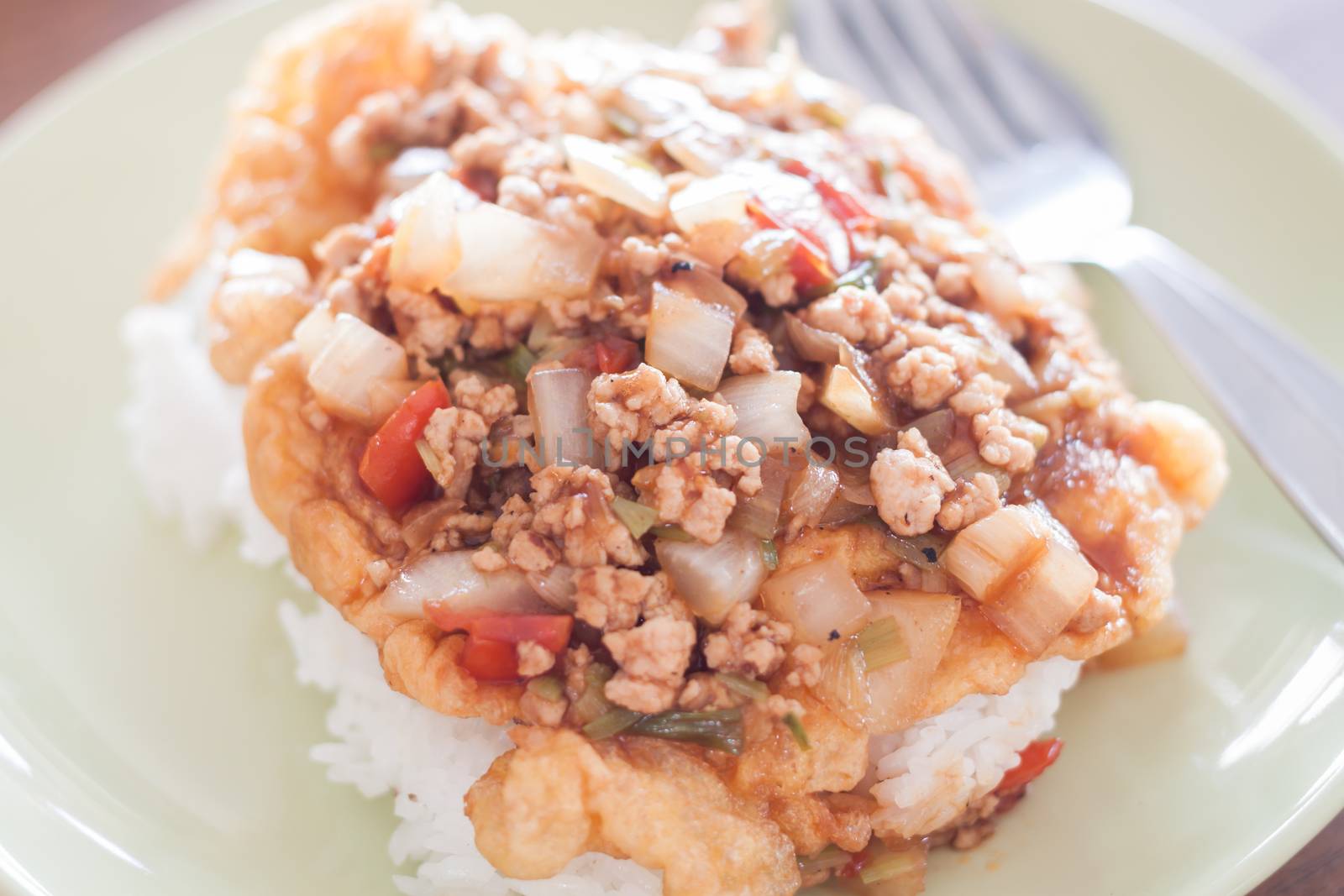 Fried pork with tomato sauce topping on fried egg, stock photo