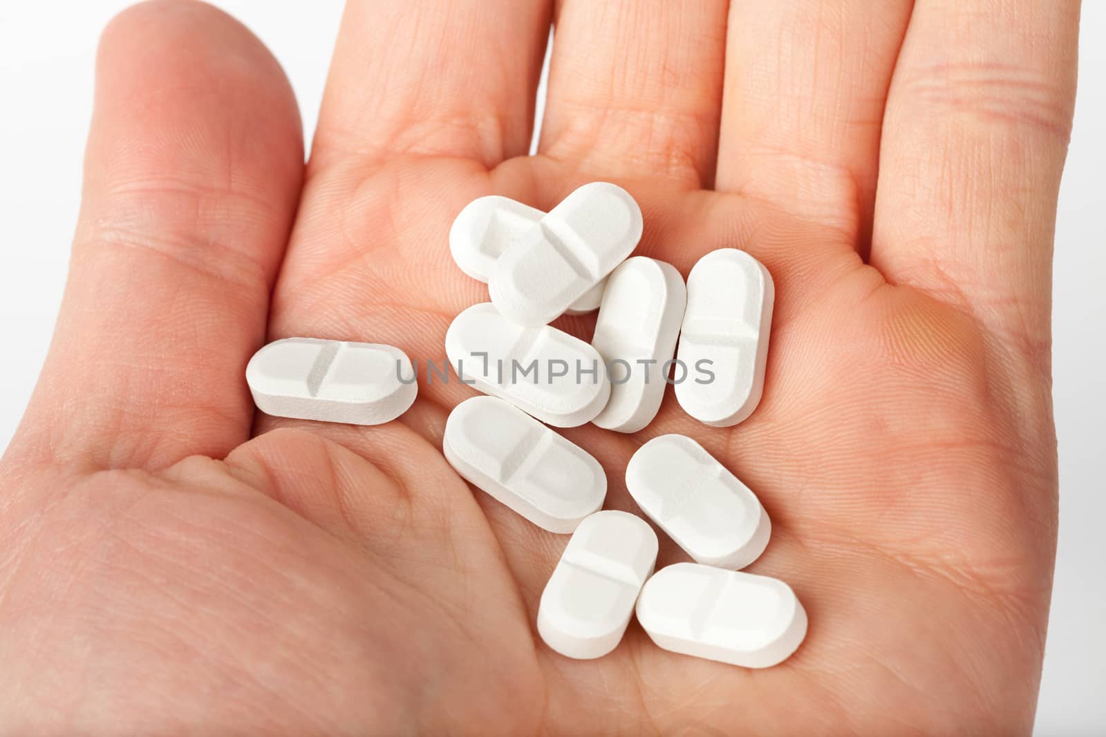 white pills in the hand. medicine concept