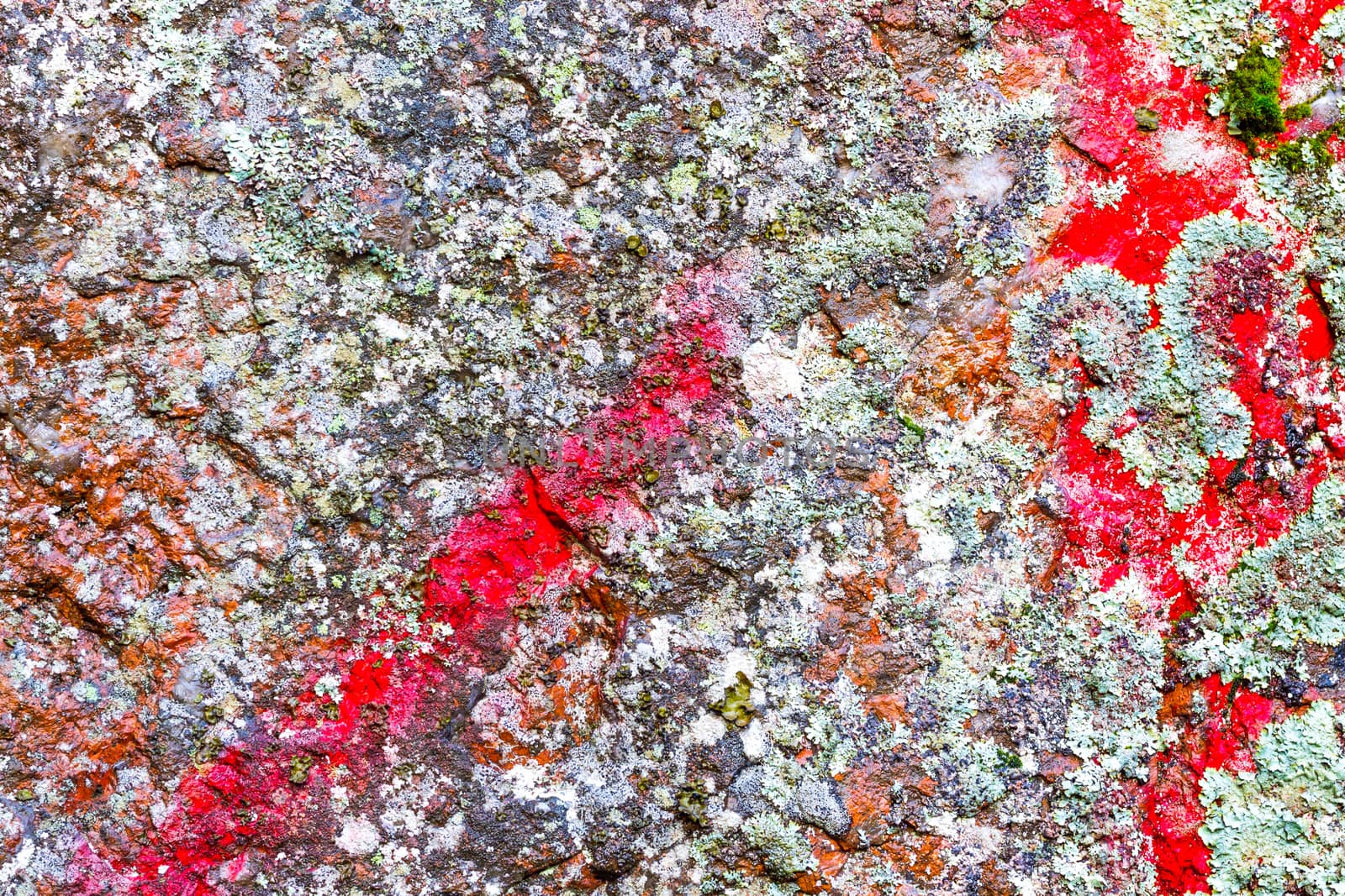 Natural colorful rock background with red paint