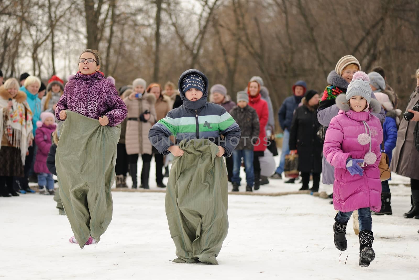 Children sack-racing during winter Maslenitsa 2015, carnival in Russia