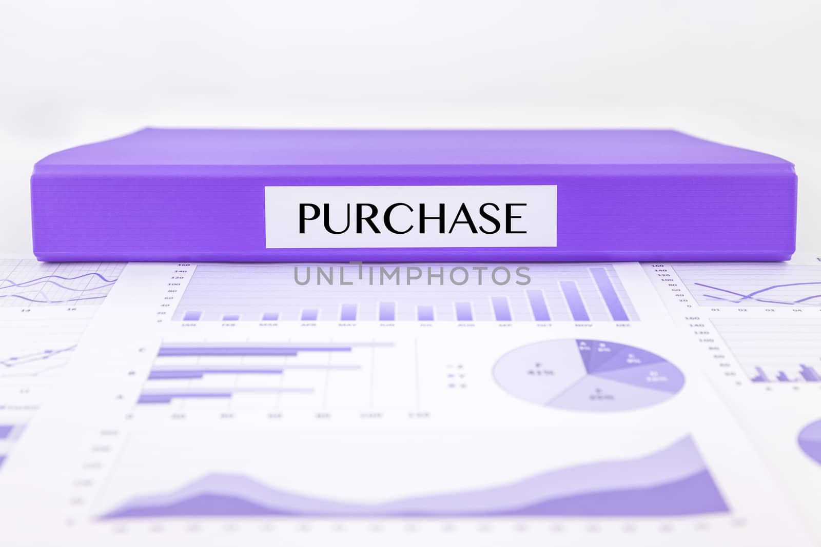 Purple document binder with PURCHASE word place on graph analysis and  budget plan