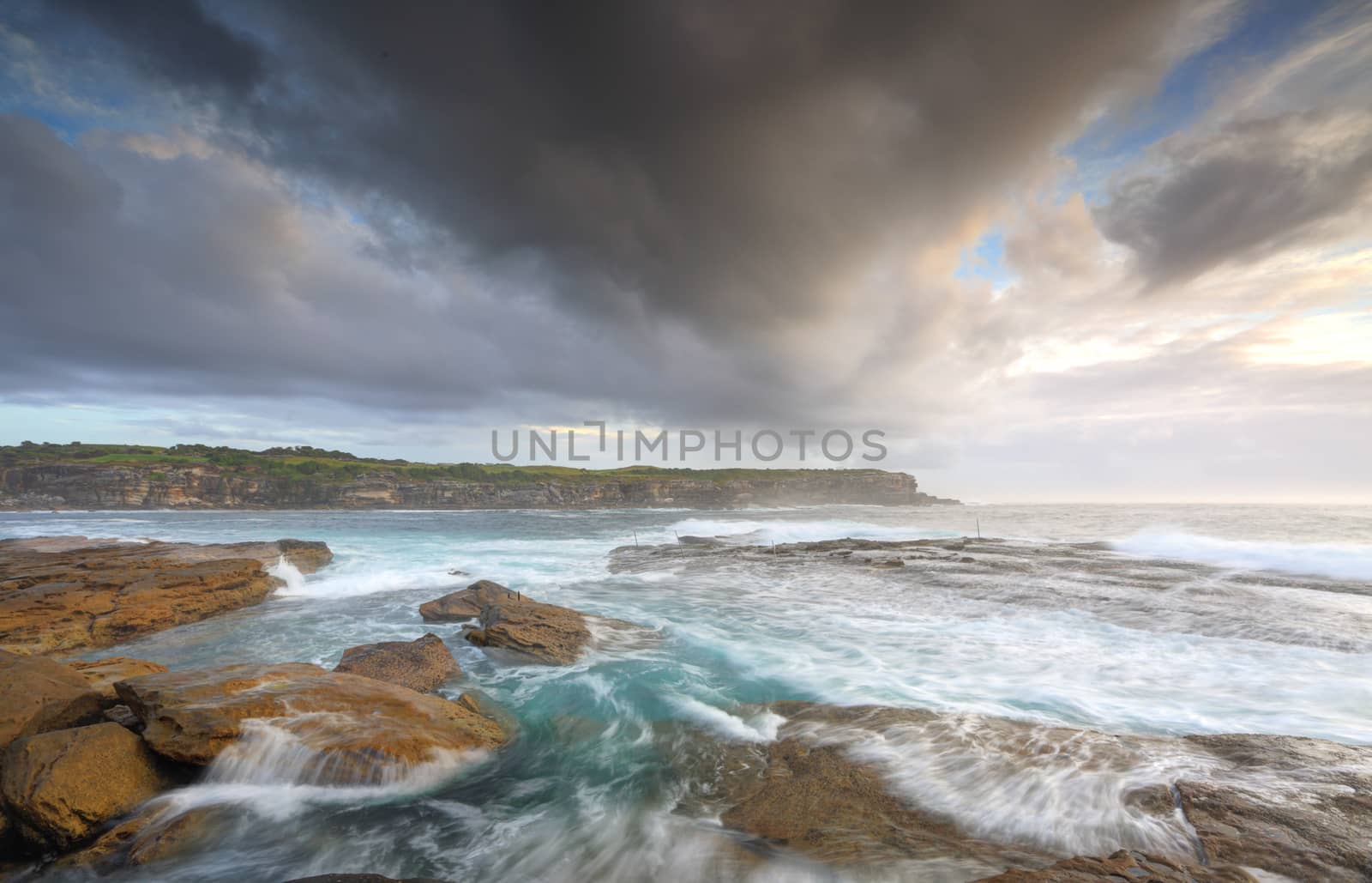 Views from the southern rockshelf at Little Bay looking across to its northern headland.